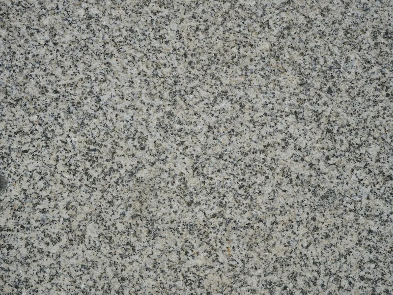 Close-up of a gray and white flake epoxy garage floor finish